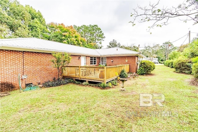 back of house with a yard and a deck