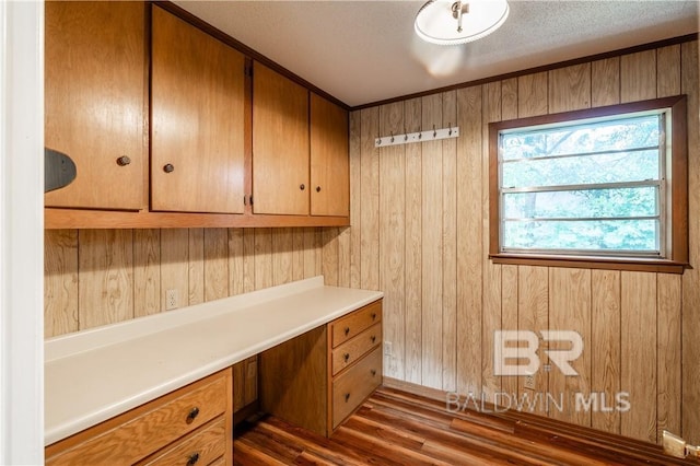 unfurnished office featuring wooden walls