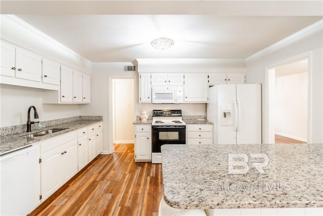 kitchen with white appliances, white cabinetry, and sink