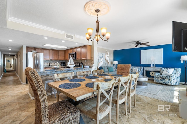 dining area featuring recessed lighting, visible vents, ornamental molding, and ceiling fan with notable chandelier