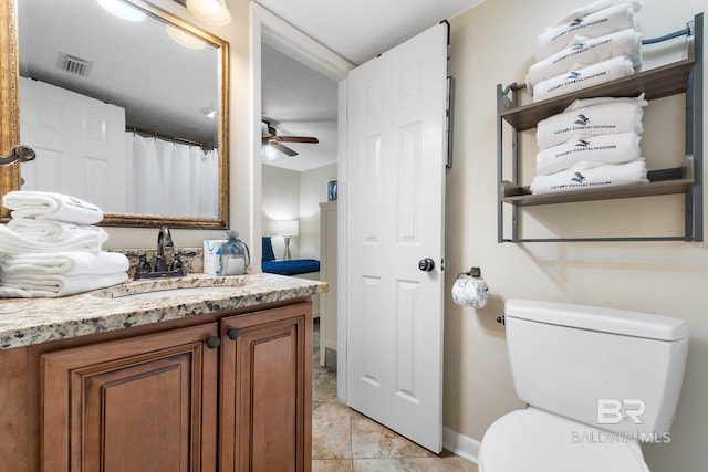 bathroom with visible vents, a ceiling fan, toilet, tile patterned floors, and vanity