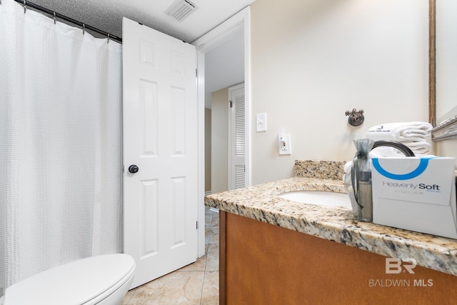 full bath featuring a closet, visible vents, toilet, vanity, and tile patterned flooring