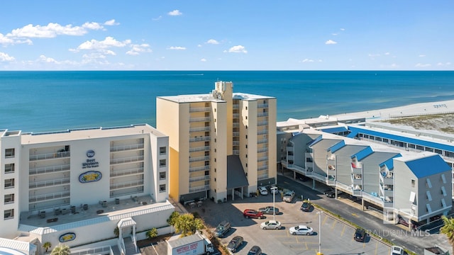 drone / aerial view featuring a water view and a beach view