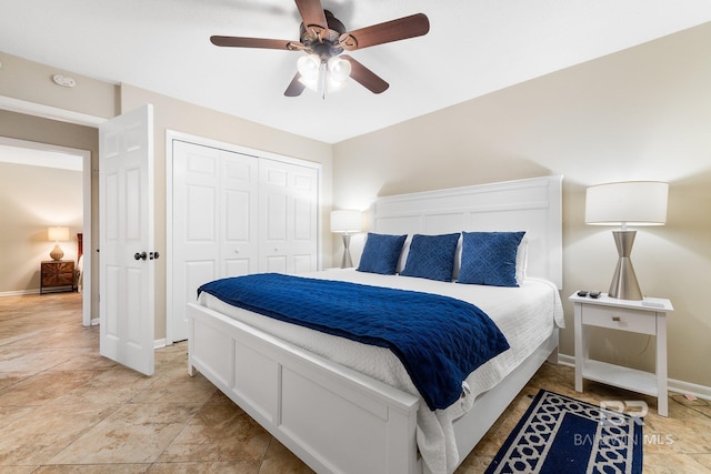 bedroom featuring ceiling fan, a closet, and baseboards