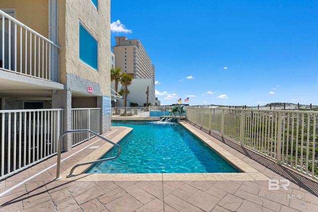 pool featuring a patio and fence