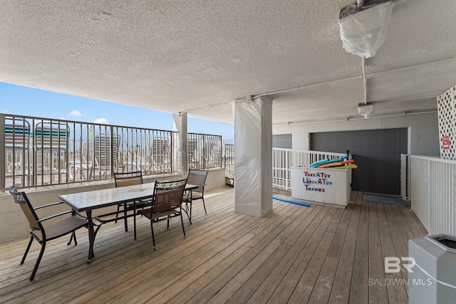 wooden terrace featuring outdoor dining area