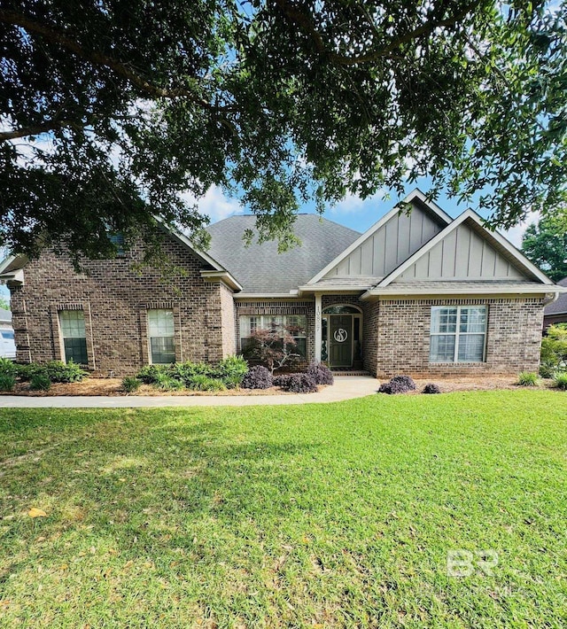 craftsman-style home with brick siding, a front lawn, and board and batten siding