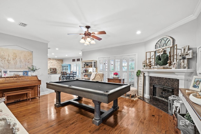 rec room featuring a ceiling fan, visible vents, a fireplace, wood finished floors, and recessed lighting