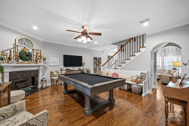 playroom with arched walkways, ceiling fan, wood finished floors, and visible vents