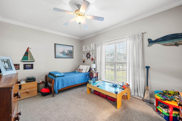 bedroom with carpet floors, ornamental molding, and a ceiling fan