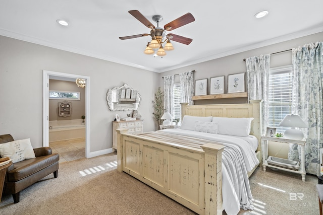 bedroom featuring multiple windows, ornamental molding, connected bathroom, and light colored carpet
