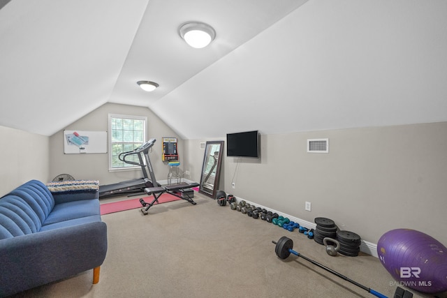 workout area featuring baseboards, visible vents, carpet, and lofted ceiling