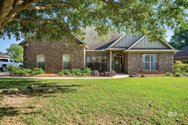 craftsman-style home featuring board and batten siding, brick siding, and a front yard