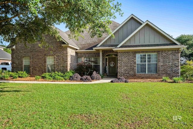 craftsman-style home featuring board and batten siding, brick siding, and a front yard
