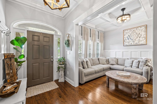 foyer with crown molding, dark wood-style floors, a chandelier, coffered ceiling, and a wealth of natural light