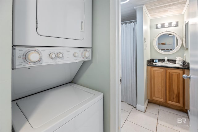 23044 Perdido Beach Blvd Unit 338, Orange Beach, AL 36561 - laundry room featuring stacked washer and clothes dryer and light tile patterned floors