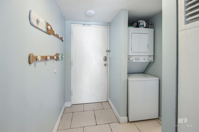 23044 Perdido Beach Blvd Unit 338, Orange Beach, AL 36561 - washroom with stacked washer / dryer, baseboards, and light tile patterned flooring