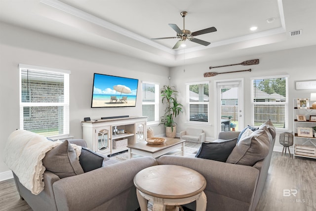 9365 Eiland Dr, Foley, AL 36535 - living room with a raised ceiling, wood finished floors, ceiling fan, ornamental molding, and baseboards