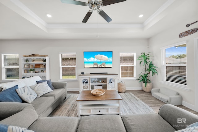 9365 Eiland Dr, Foley, AL 36535 - living room with a tray ceiling, wood finished floors, baseboards, crown molding, and a ceiling fan