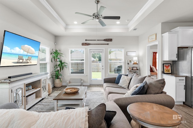 9365 Eiland Dr, Foley, AL 36535 - living room with a raised ceiling, light wood-style flooring, a ceiling fan, ornamental molding, and recessed lighting