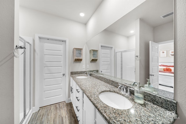 9365 Eiland Dr, Foley, AL 36535 - ensuite bathroom featuring a stall shower, wood finished floors, double vanity, and recessed lighting