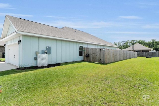 9365 Eiland Dr, Foley, AL 36535 - rear view of house with board and batten siding, a garage, and roof with shingles
