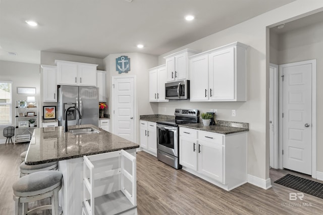 9365 Eiland Dr, Foley, AL 36535 - kitchen with appliances with stainless steel finishes, a sink, light wood finished floors, and recessed lighting