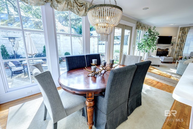 dining space featuring a wealth of natural light, a notable chandelier, and hardwood / wood-style floors