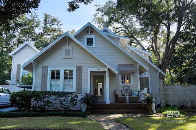 bungalow-style house with a front lawn