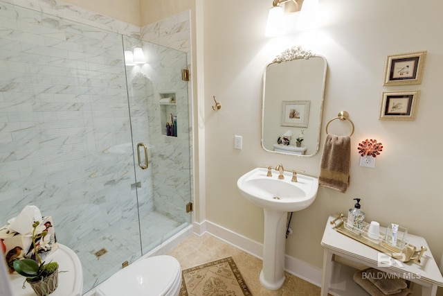 bathroom with a shower with shower door, tile flooring, and toilet