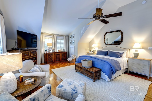 bedroom with ceiling fan, vaulted ceiling, and hardwood / wood-style floors