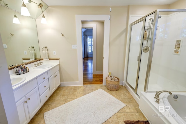 bathroom with dual vanity, tile flooring, and independent shower and bath