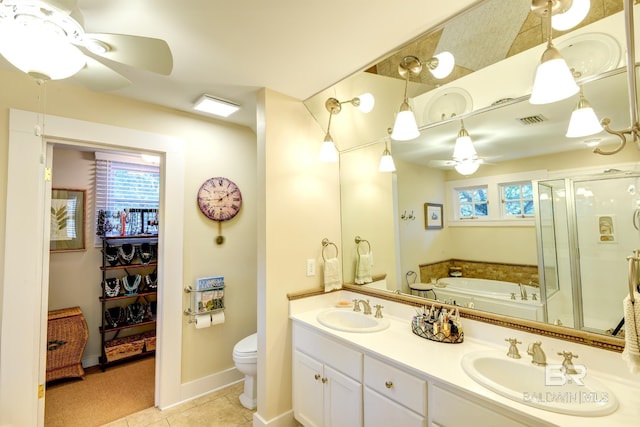 bathroom featuring dual sinks, ceiling fan, tile flooring, a tub, and toilet