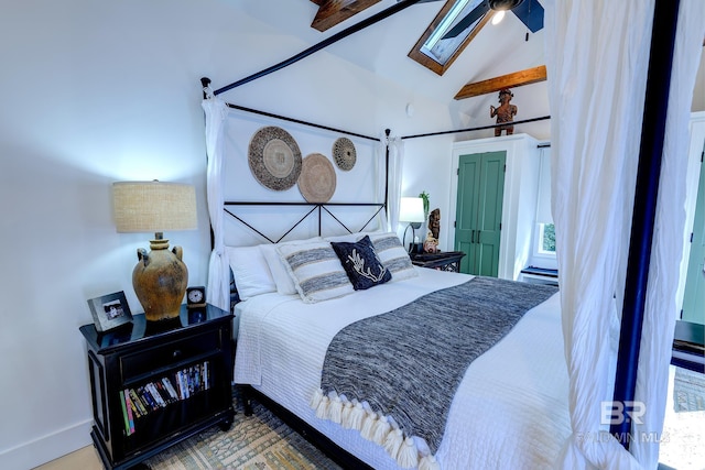 bedroom with ceiling fan and vaulted ceiling with beams