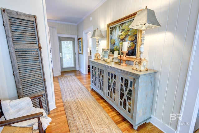 hall featuring hardwood / wood-style floors and ornamental molding