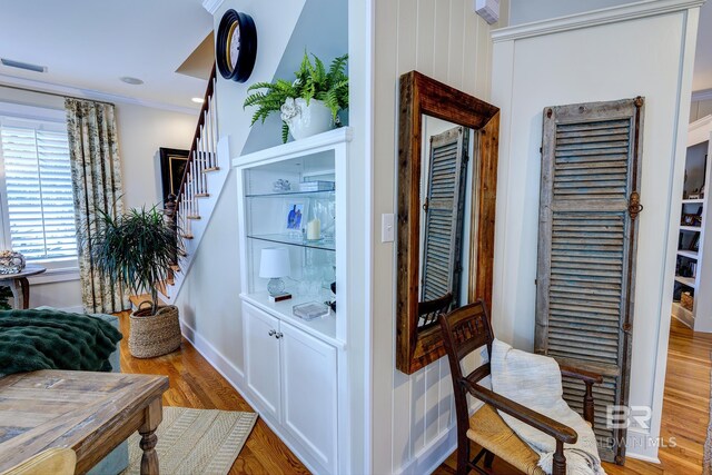 interior space featuring ornamental molding and hardwood / wood-style flooring