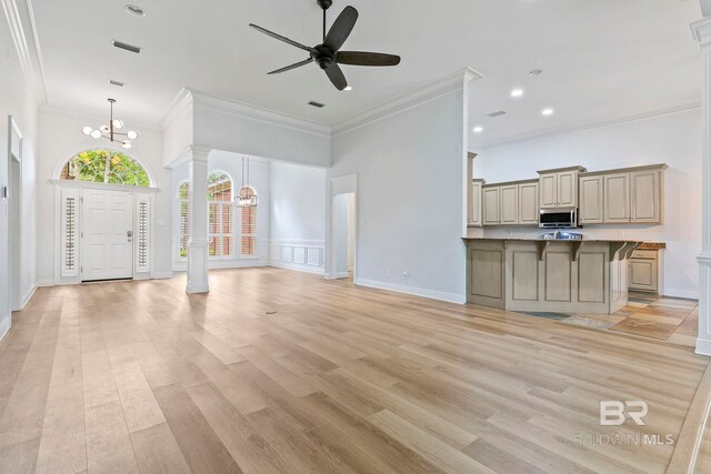 interior space featuring wood ceiling, brick wall, ceiling fan, light hardwood / wood-style flooring, and ornamental molding