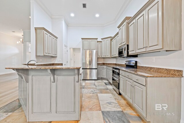 kitchen featuring dark stone counters, pendant lighting, sink, appliances with stainless steel finishes, and ornamental molding