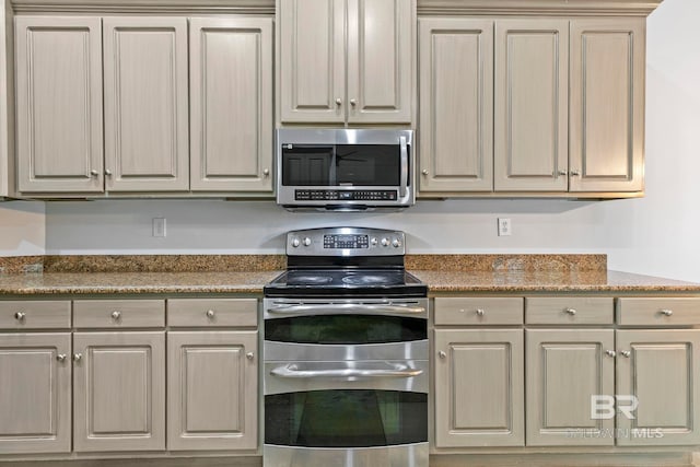 kitchen featuring appliances with stainless steel finishes and stone counters