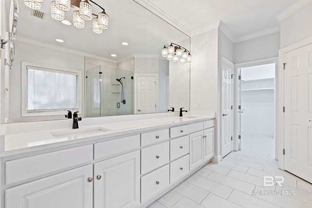 bathroom with ornamental molding, tile patterned floors, a shower with shower door, and vanity