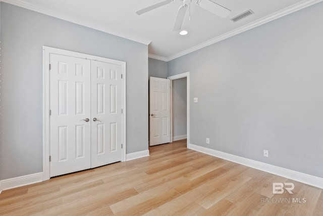 unfurnished bedroom with light hardwood / wood-style flooring, a closet, ceiling fan, and crown molding