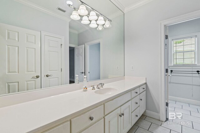 bathroom with vanity, ornamental molding, and tile patterned floors