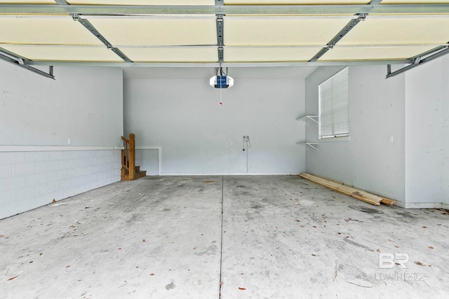 garage with a garage door opener and a carport