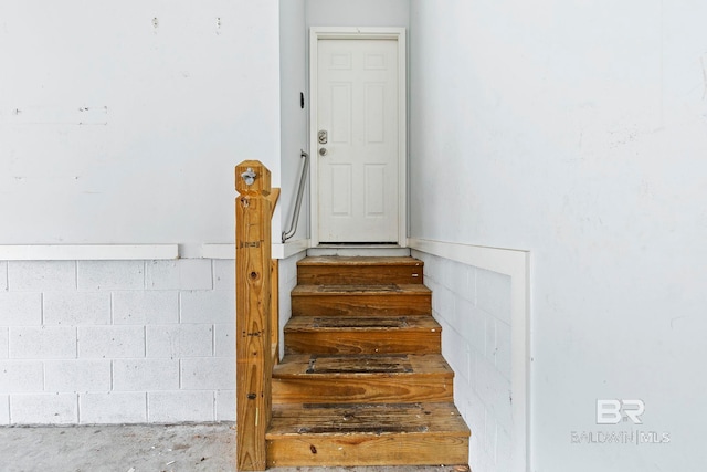 staircase with concrete floors