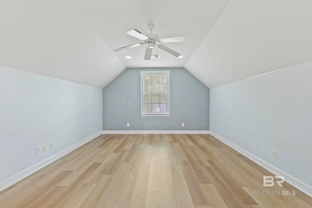 additional living space featuring light hardwood / wood-style floors, vaulted ceiling, and ceiling fan