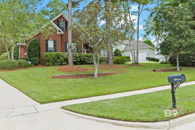 view of front of home with a front yard and a garage