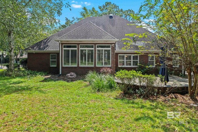 back of house with a lawn