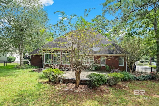 back of house with a patio area and a yard