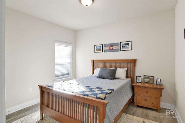 bedroom with hardwood / wood-style floors