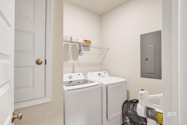 clothes washing area with electric panel and washer and dryer